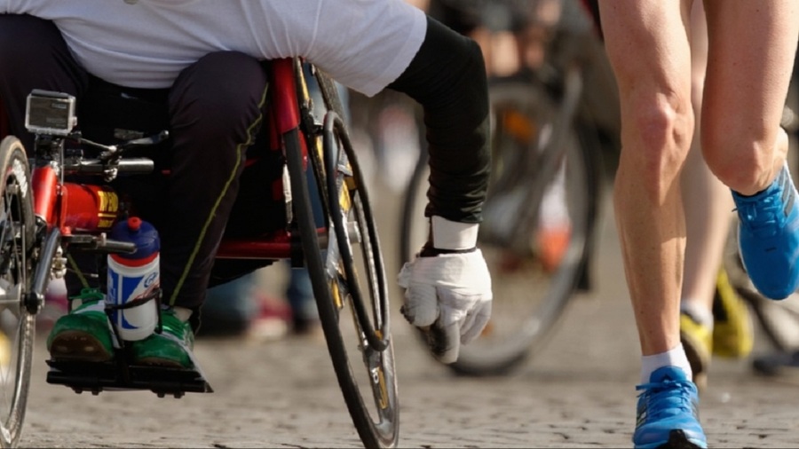 Wheelchair racer and runners