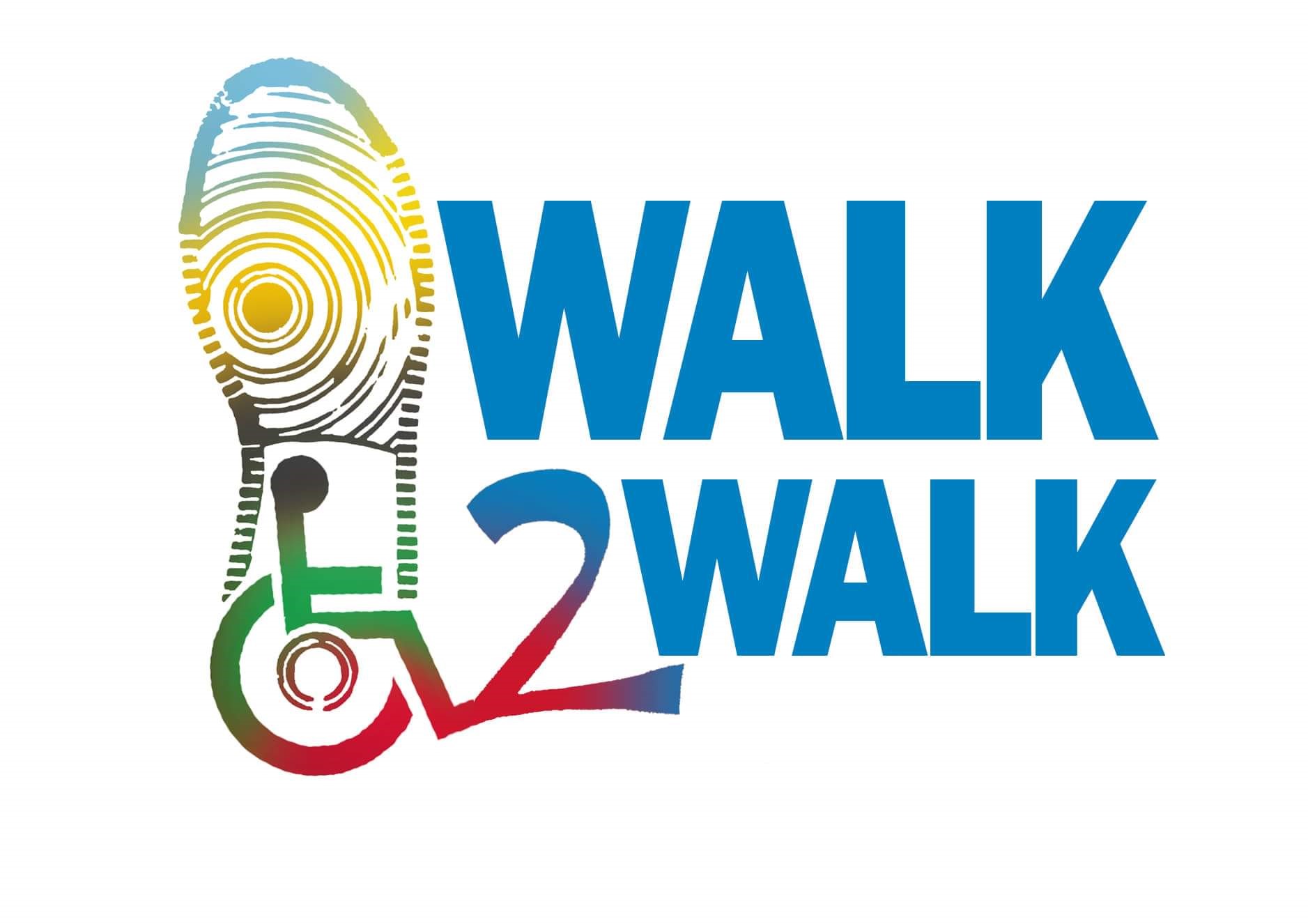 Walk2Walk multicolor logo with a shoe print with universal wheelchair symbol inside and works walk 2 walk